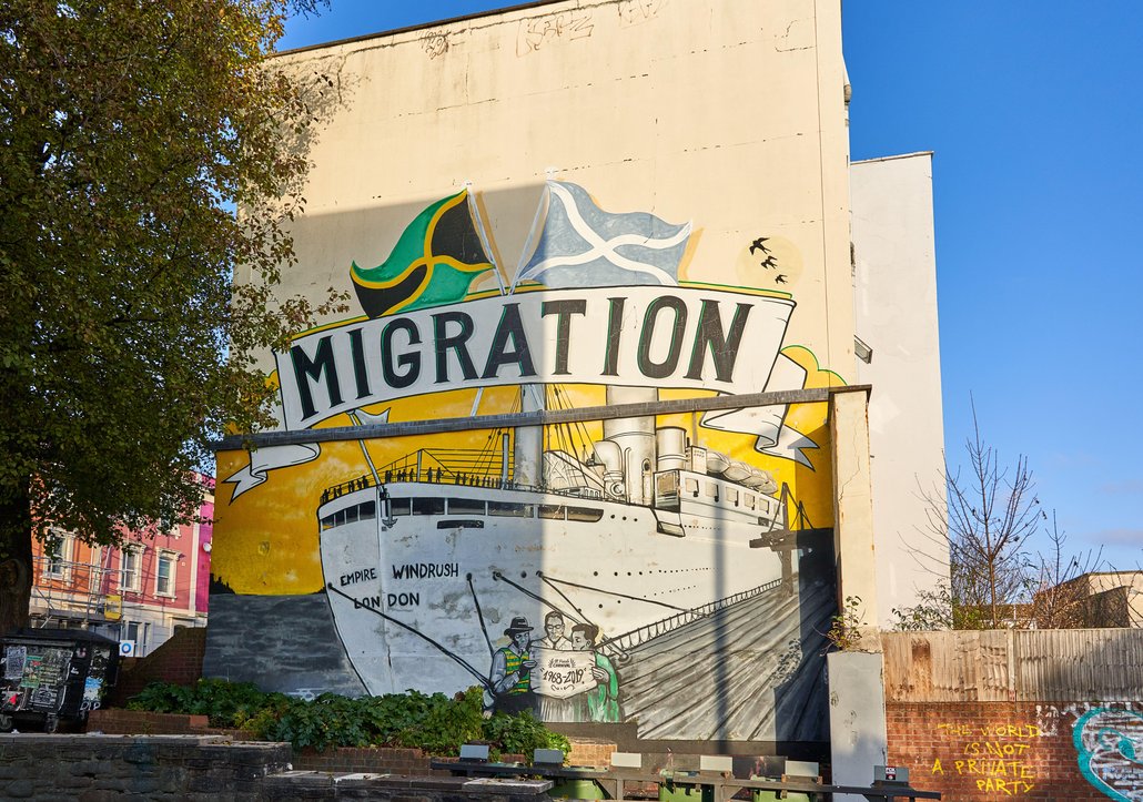 A mural of the Windrush boat, above which it says 'Migration'